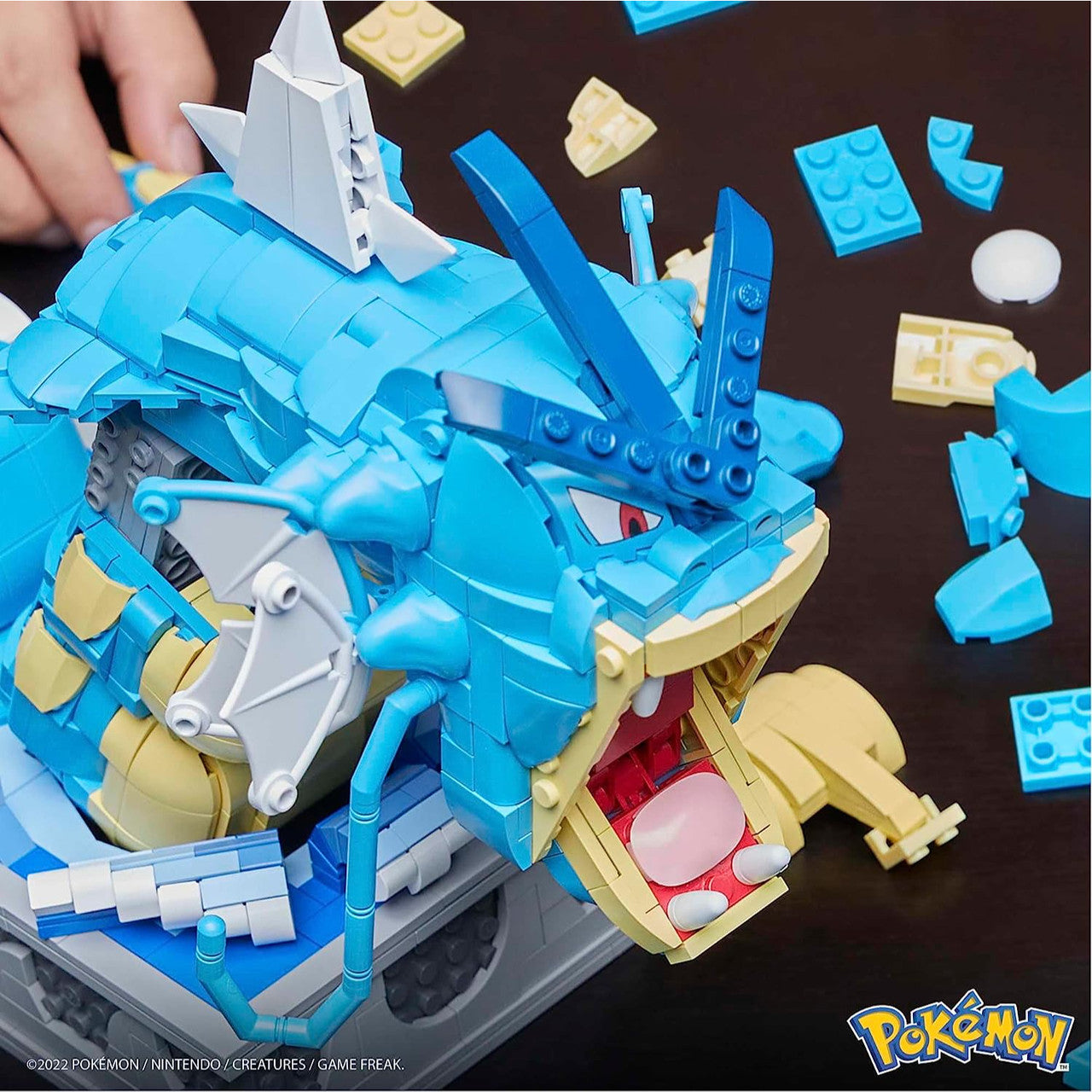 This is brand new.Build a detailed and elaborate Gyarados with this fully mechanized building set, which is mounted on a display and features animated movements like an opening mouth, flapping tail and pivoting neck when the toy is activated by a hand-turned crank.